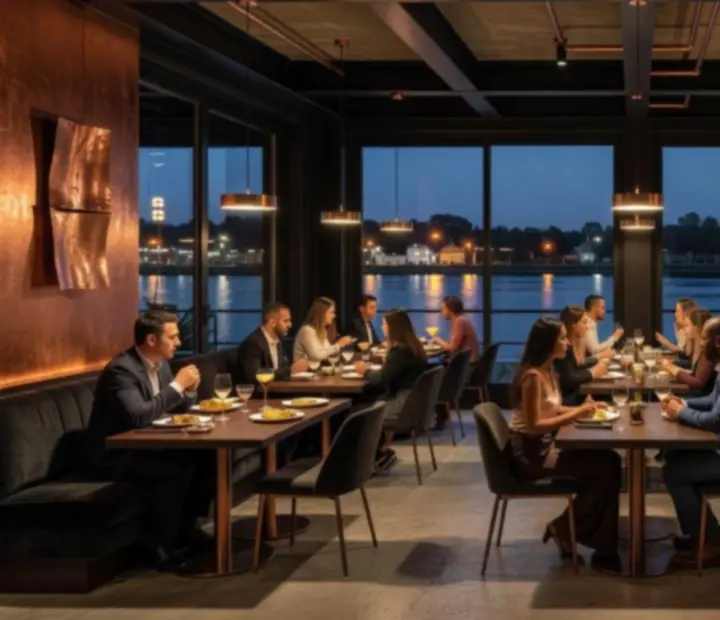 Industrial riverside interior of River & Roast with copper accents and dark seating